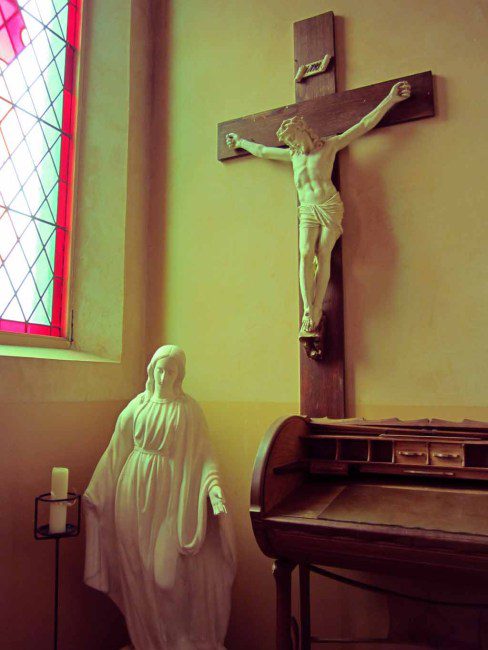 A statue of the Virgin Mary and a crucifx.