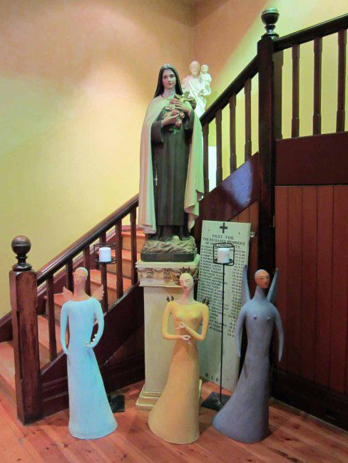 A statue of the Virgin Mary and three other female statues.