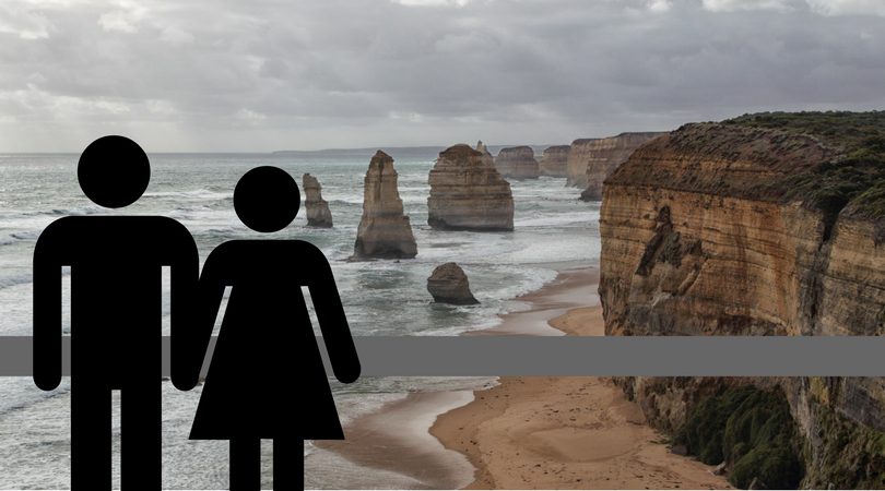 A male and female figure next to a view of the Twelve Apostles.