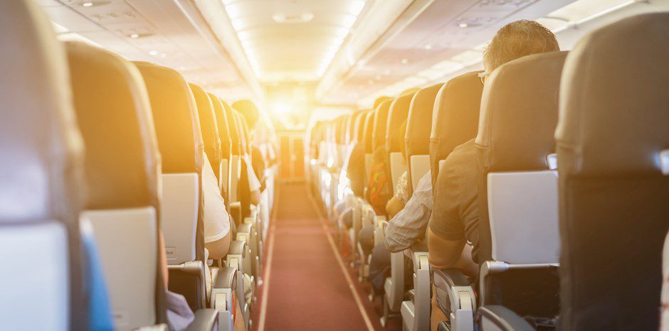 An airplane cabin. A long flight.