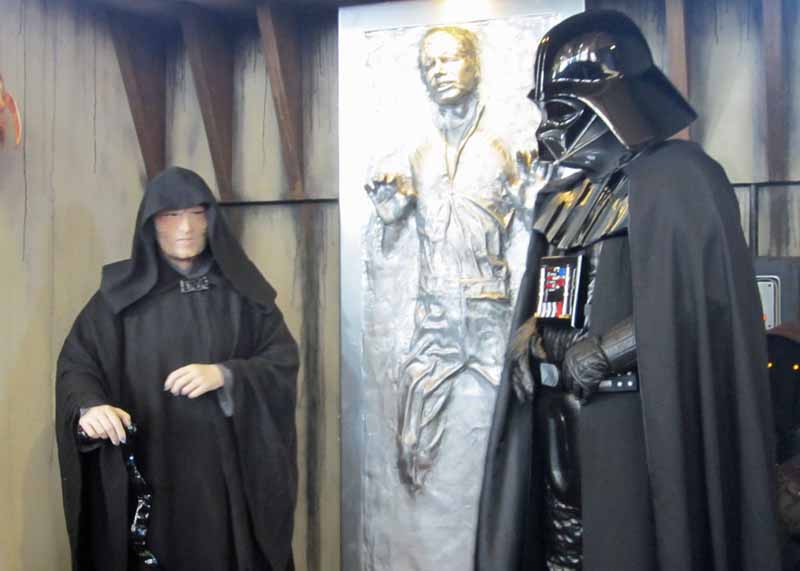 Emperor Palpatine and Darth Vader with poor Han Solo frozen in carbonite.