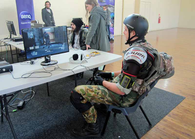 A guy in costume playing a video game.