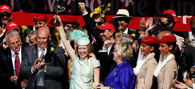 Gai Waterhouse holding up her Melbourne Cup.