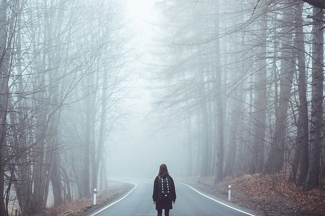 A person on a foggy road. Expat life, wanderers.