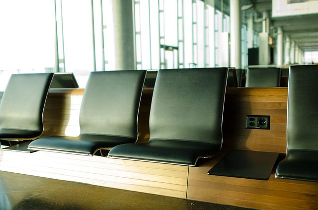 Empty seats at an airport terminal. Airport travel tips.