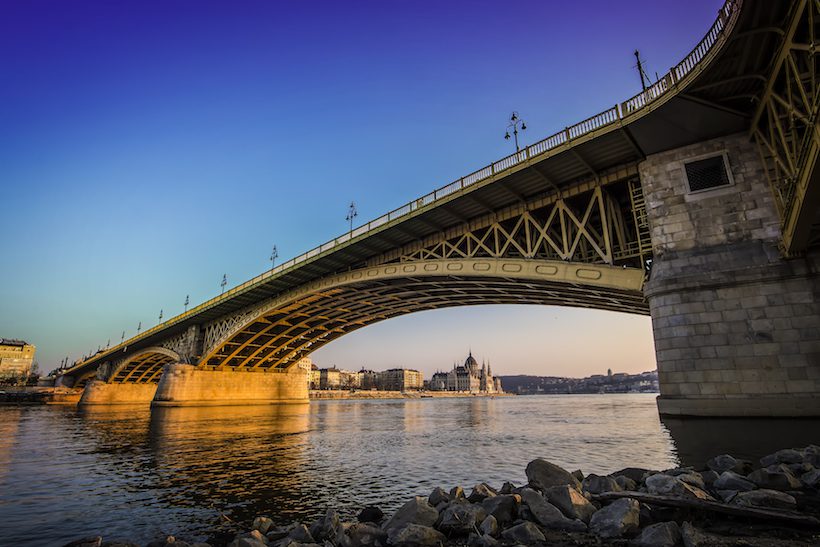 A bridge over water at sunset.
