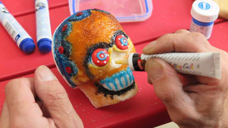 Decorating a sugar skull.
