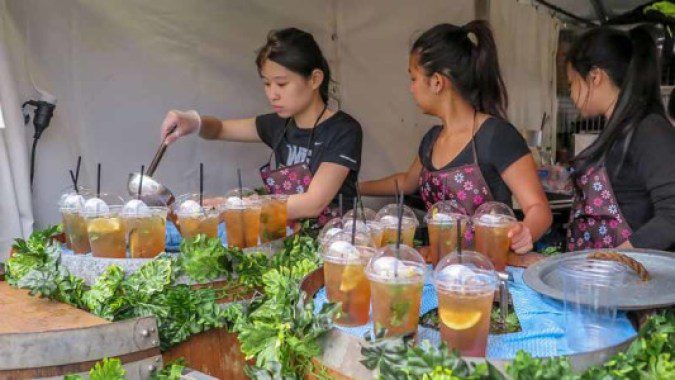 Two women pouring drinks.
