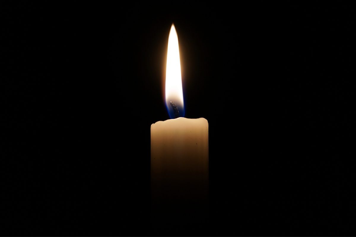 Lit candle on a black background