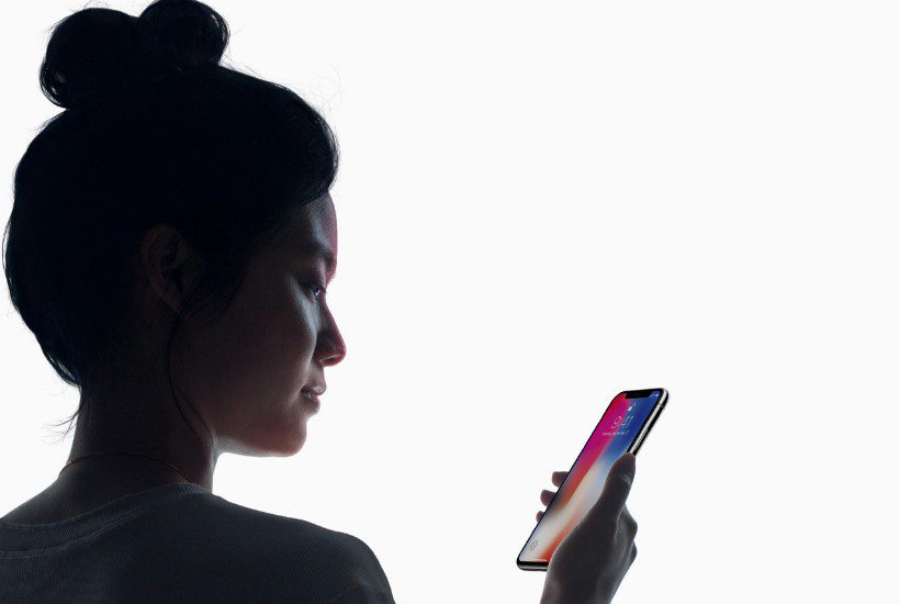 Woman looking at iPhone X.