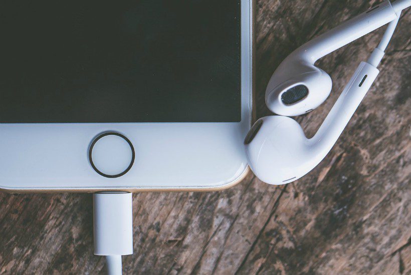 iPhone and earbuds. Podcasts for writers.
