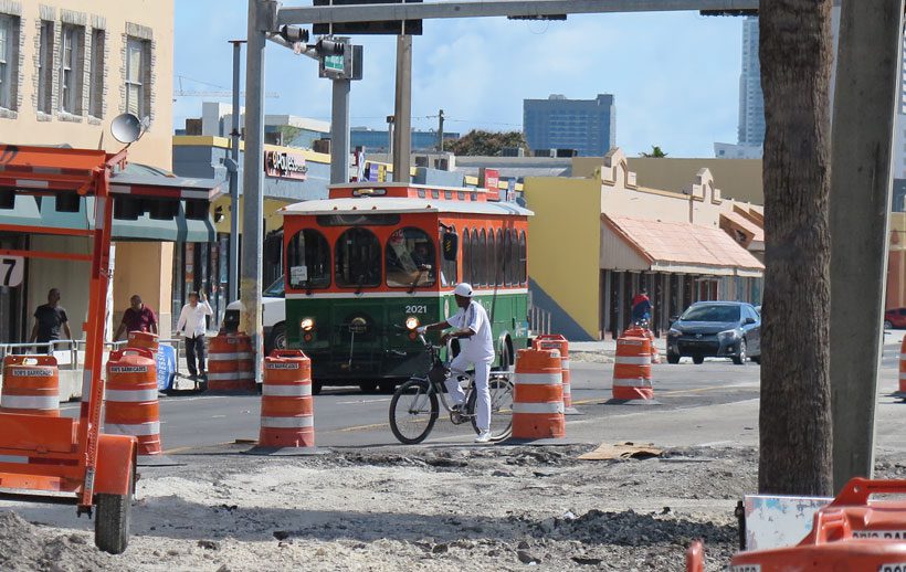A trolley and people on Flagler St in Miami.