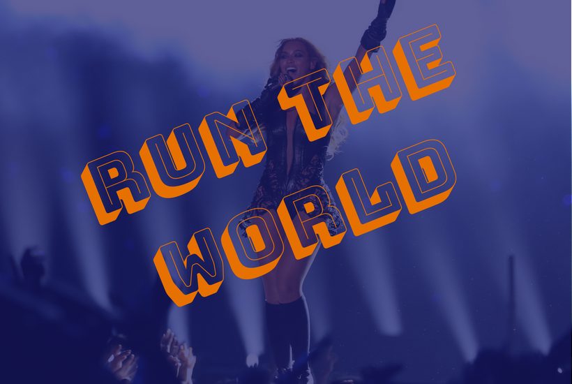 Beyonce in concert with the words "Run the World" across.