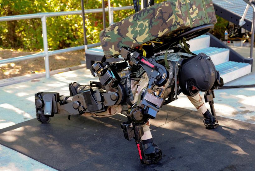 A solider performs push-ups while wearing a Raytheon XOS 2 Exoskeleton, a second-generation robotics suit.