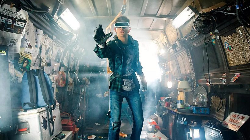 A young man wearing a VR headset and reaching out. From Ready Player One, cyber-dystopia.