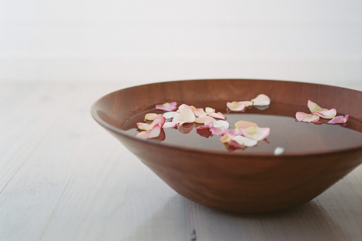 Wooden bowl with water and flowers