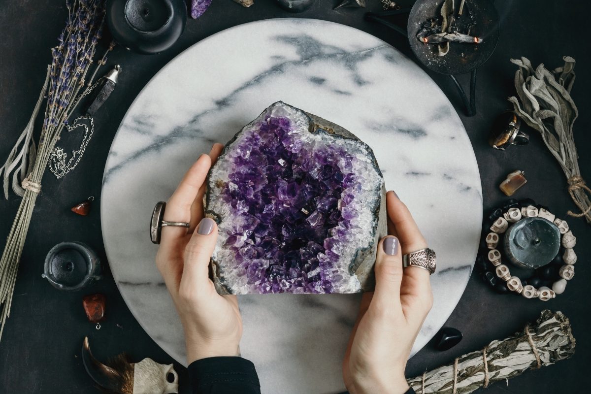 Hands holding an Amethyst cluster