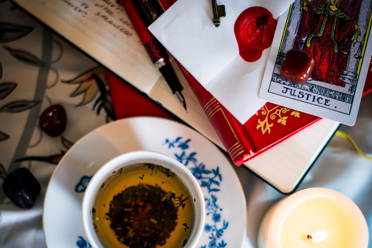 Cup of tea, books, tarot card