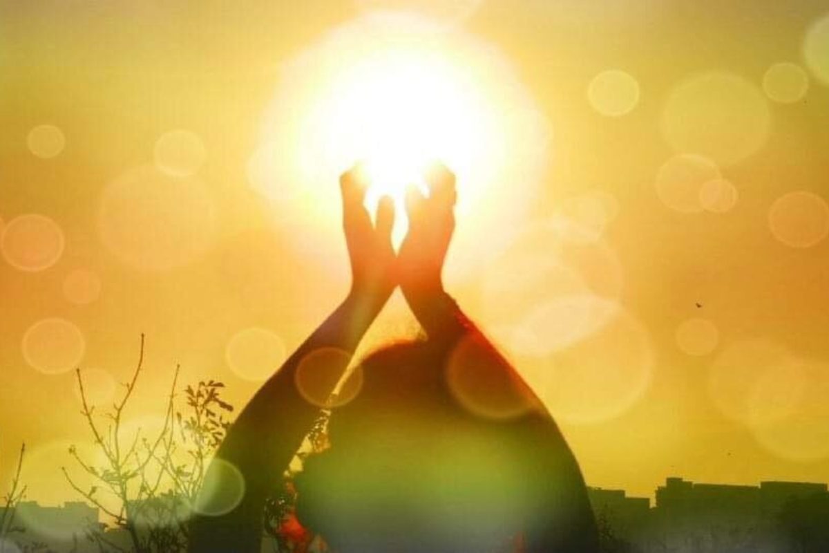Woman holding up her hands to sun