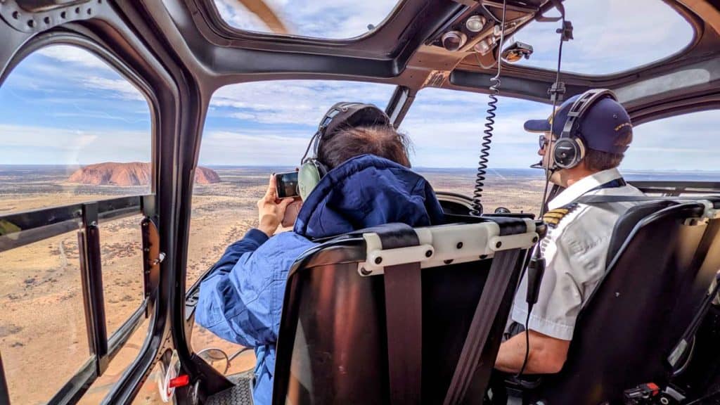 Helicopter interior with pilot and passenger.