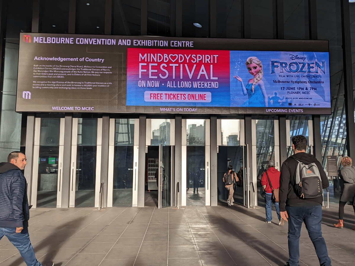 The entrance of the Melbourne Convention and Exhibition Centre with a sign promoting the MindBodySpirit Festival.