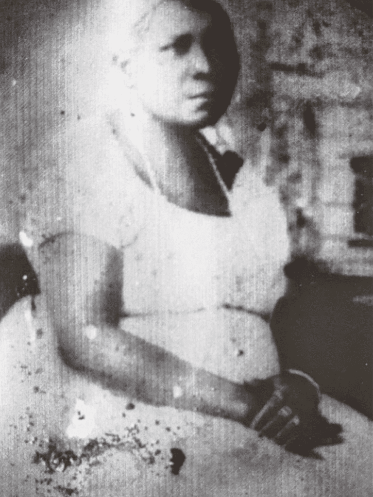 A portrait of an elderly Black woman sitting.