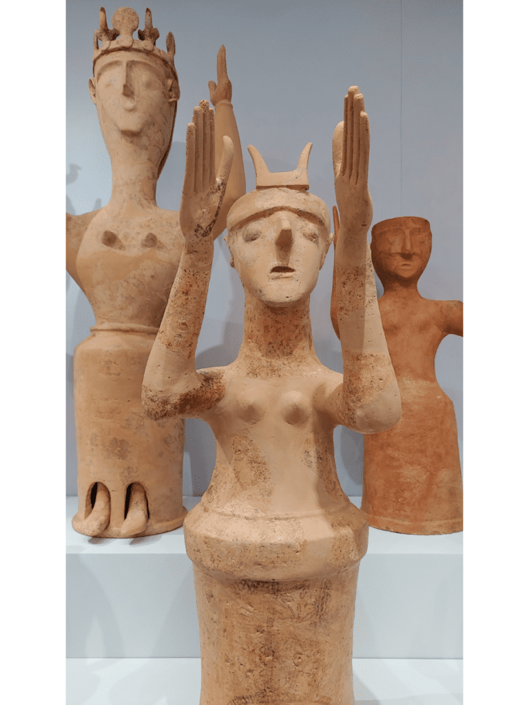 Clay figures of goddesses with upraised arms.