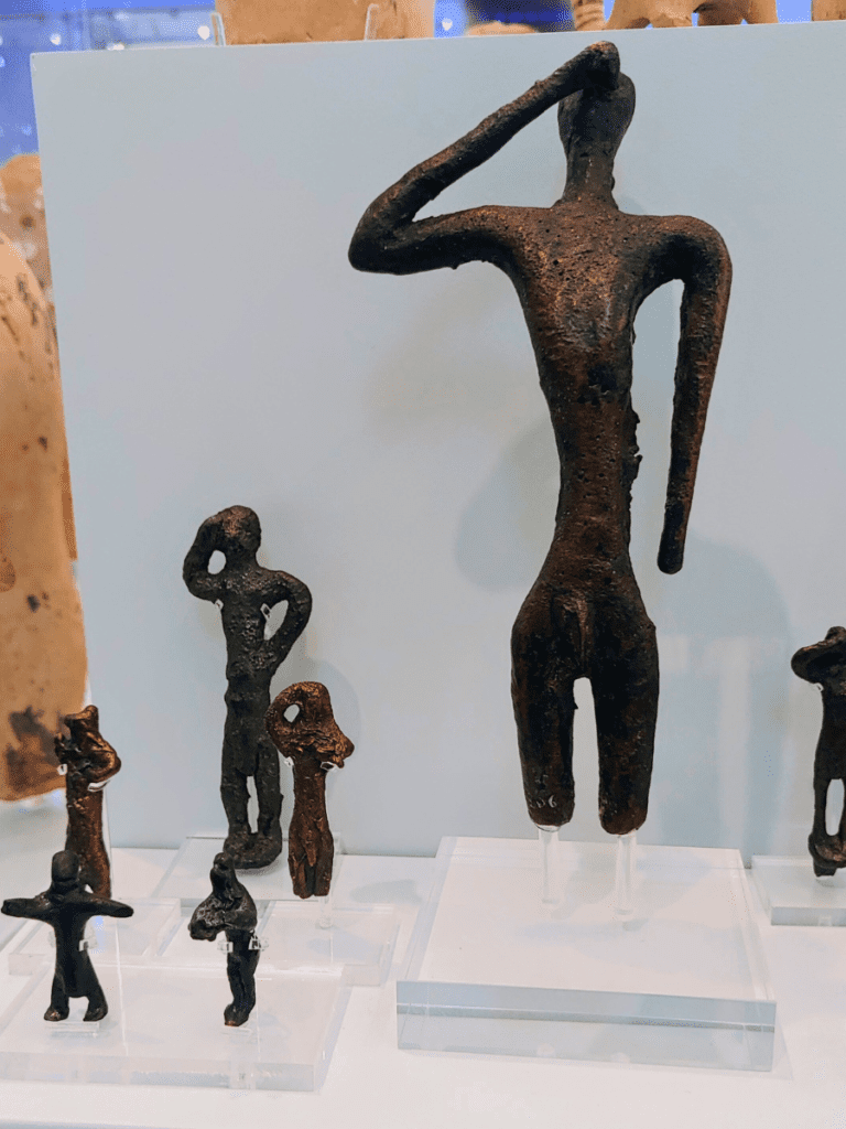 Bronze figurines of male worshippers.