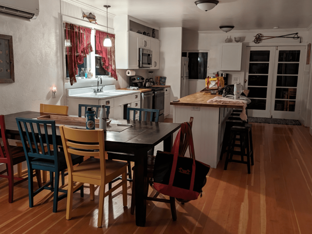 The dining room and kitchen of a house.