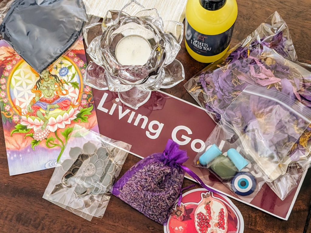 A candle, lavender sachet, sticker, room spray and other items from the goodie bag.