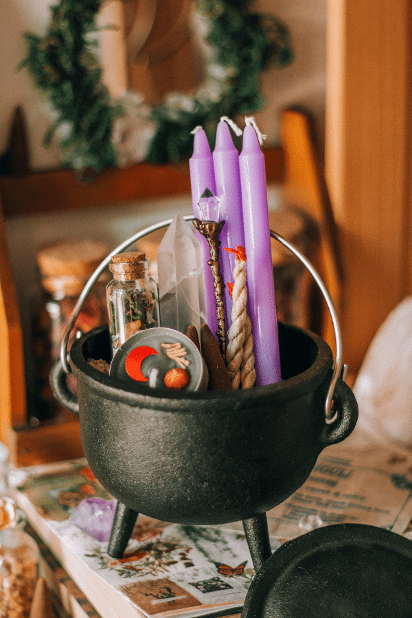 Cauldron with candles and crystals.