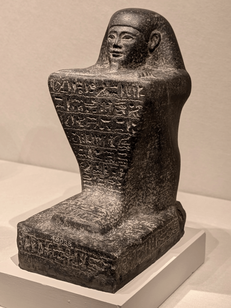 Black granite block statue of Padiamennebnesuttawy.