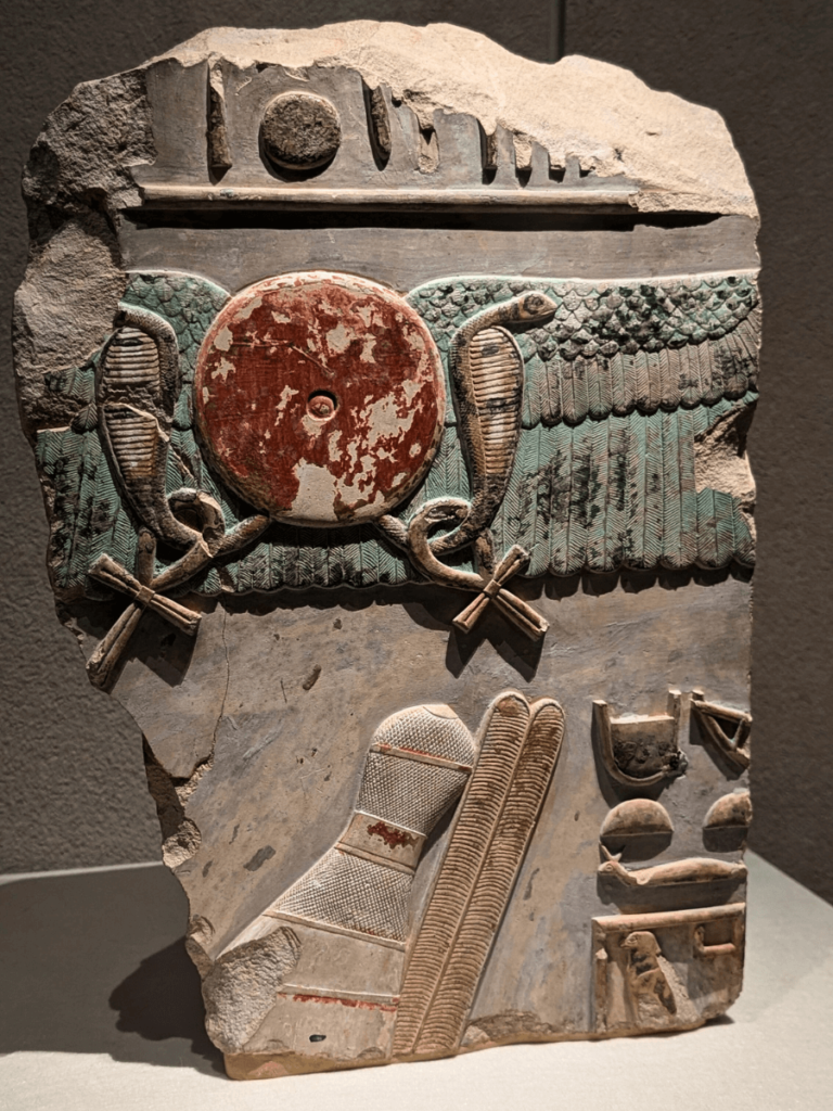 Temple relief showing King Mentuhotep II protected by the sun.