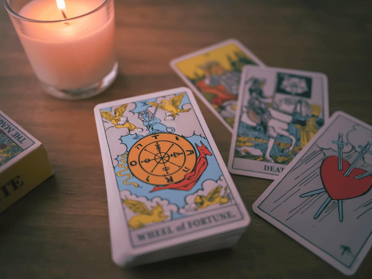 Tarot cards on a table and a candle.