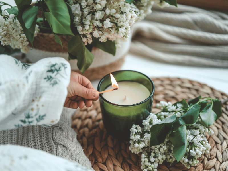 A woman's hand lighting a candle.