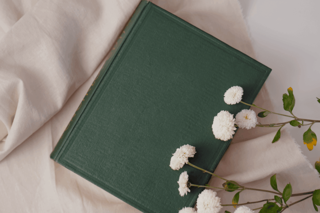 Green book and flowers for Paganism & Witchcraft Resources page.