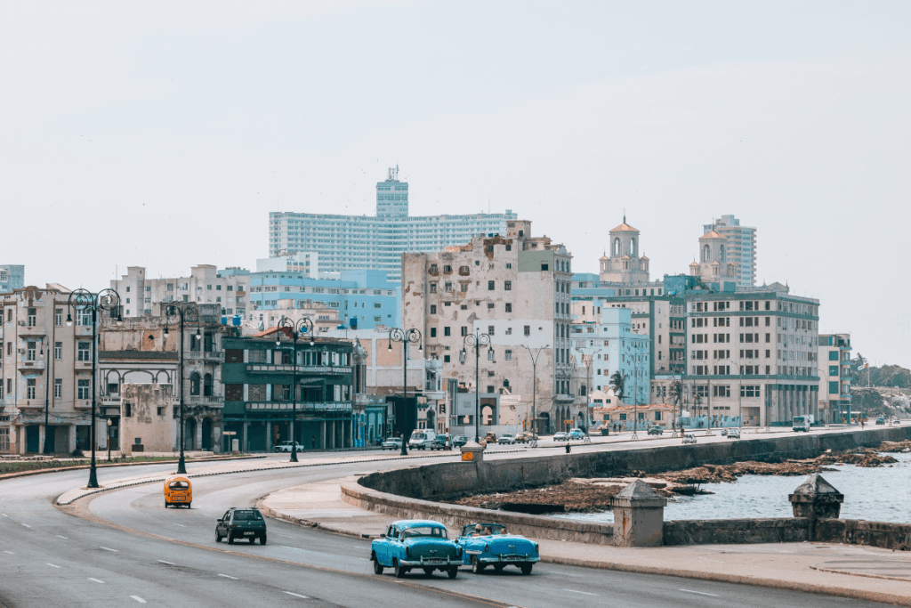 Cars driving down the road along the seawall in Havana, Cuba.