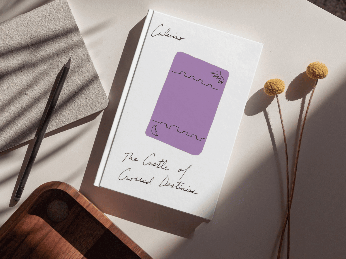 The book, Castle of Crossed Destinies against a sunlit desk background.