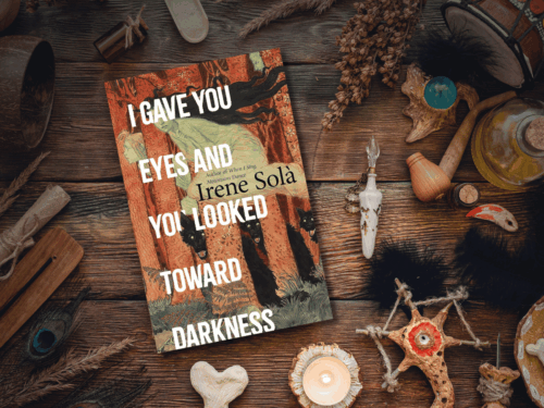 'I Gave You Eyes and You Looked Toward Darkness" book with some witchy items.