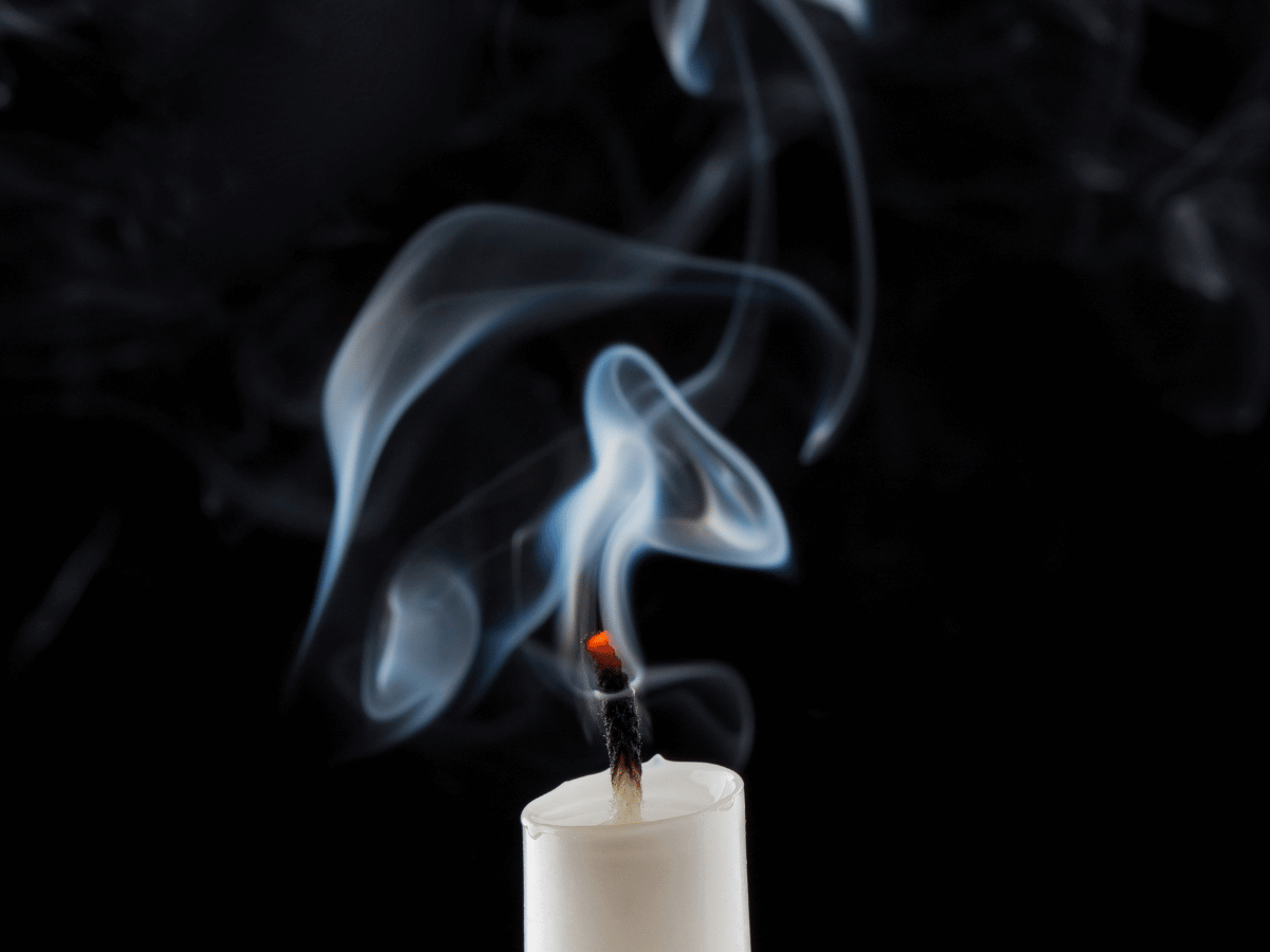 An extinguished candle with smoke.
