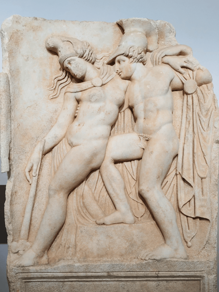 An ancient relief shows Achilles supporting the collapsing Amazon queen Penthesilea,