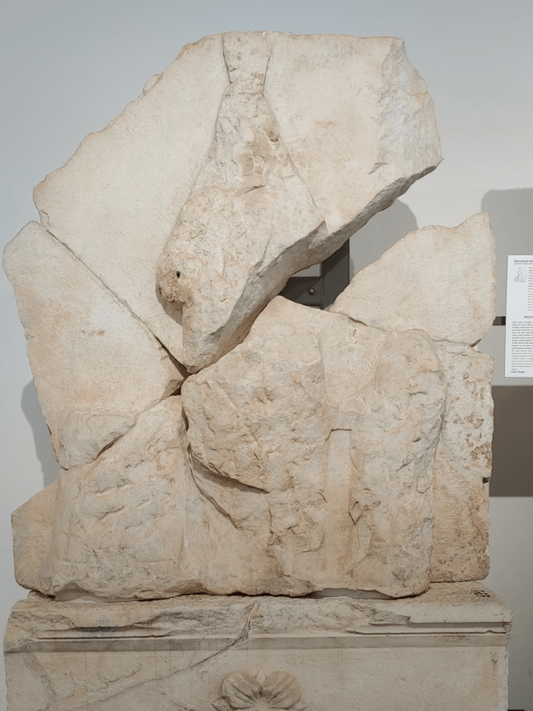 A broken and desecreated ancient relief of the goddess Aphrodite.