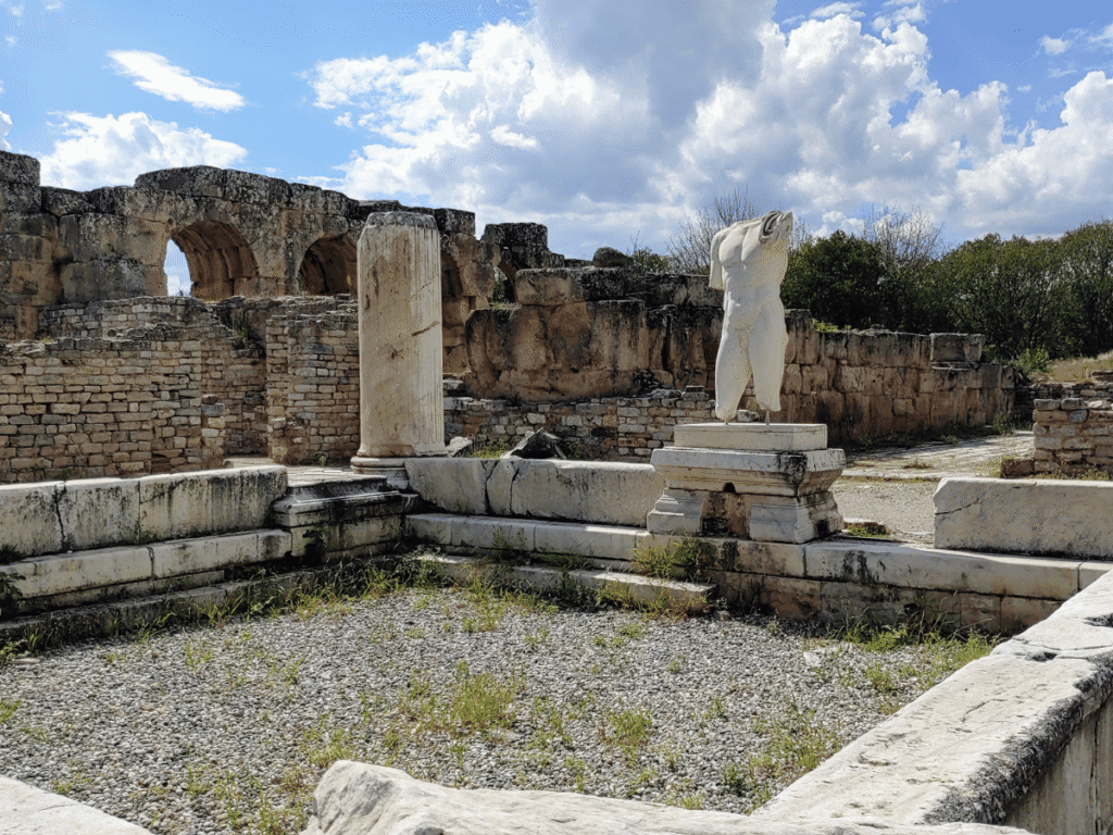 The ruins of the Baths of Hadrianus featuring a broken statue.