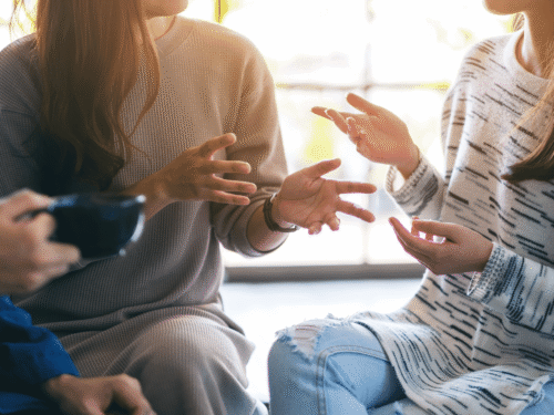 Close-up of people sitting and talking.