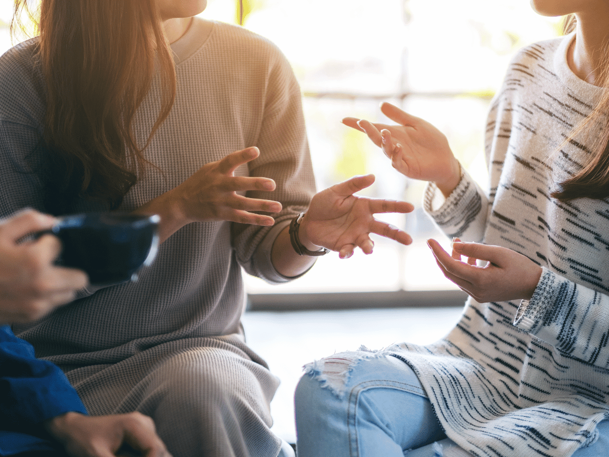 Close-up of people sitting and talking.