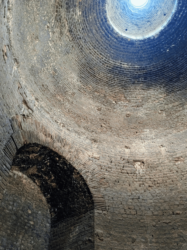 Interior of a Red Hall rotunda, looking upwards into its brick dome and circular opening