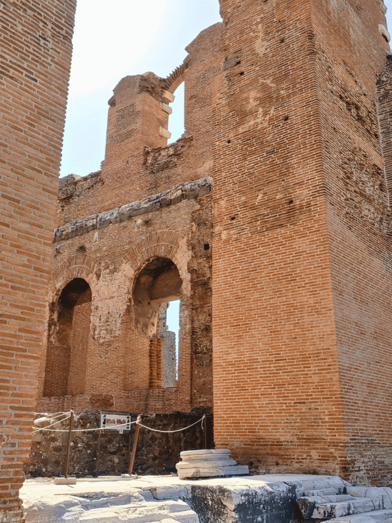 Towering red-brick walls and arched openings inside the ruins of the Red Hall.