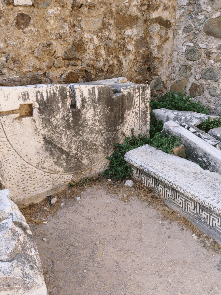 Carved marble architectural fragments at the Red Hall, including a long block decorated with a Greek key pattern.