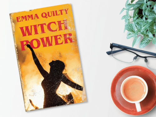 The book 'Witch Power' next to a cup of coffee and a pair of glasses.